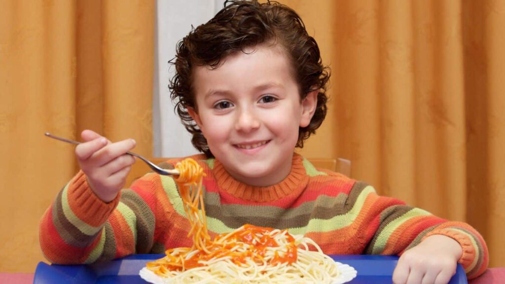 kid eating gluten free spaghetti