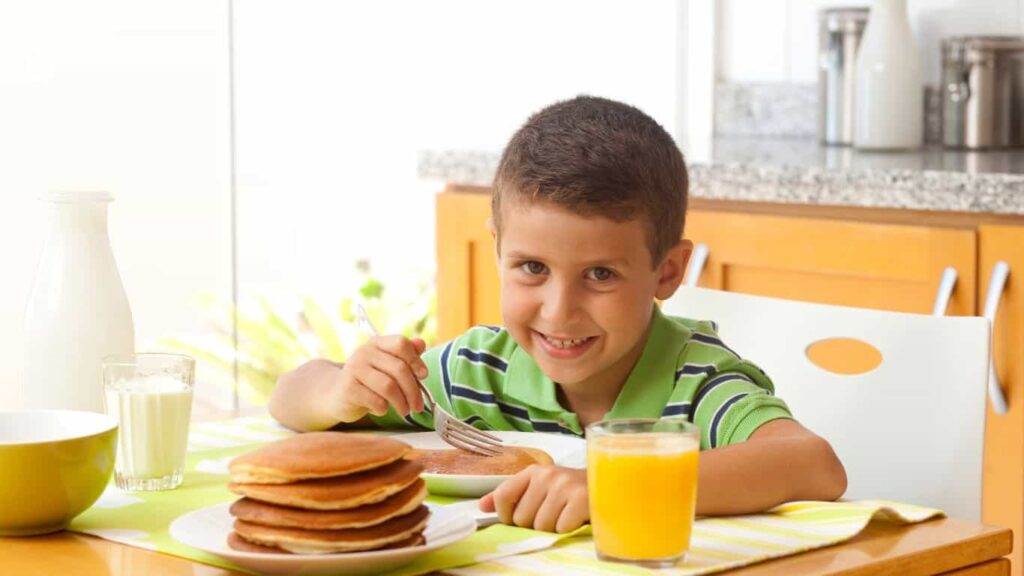 Gluten-Free Meal Planning - kid eating gluten free pancakes